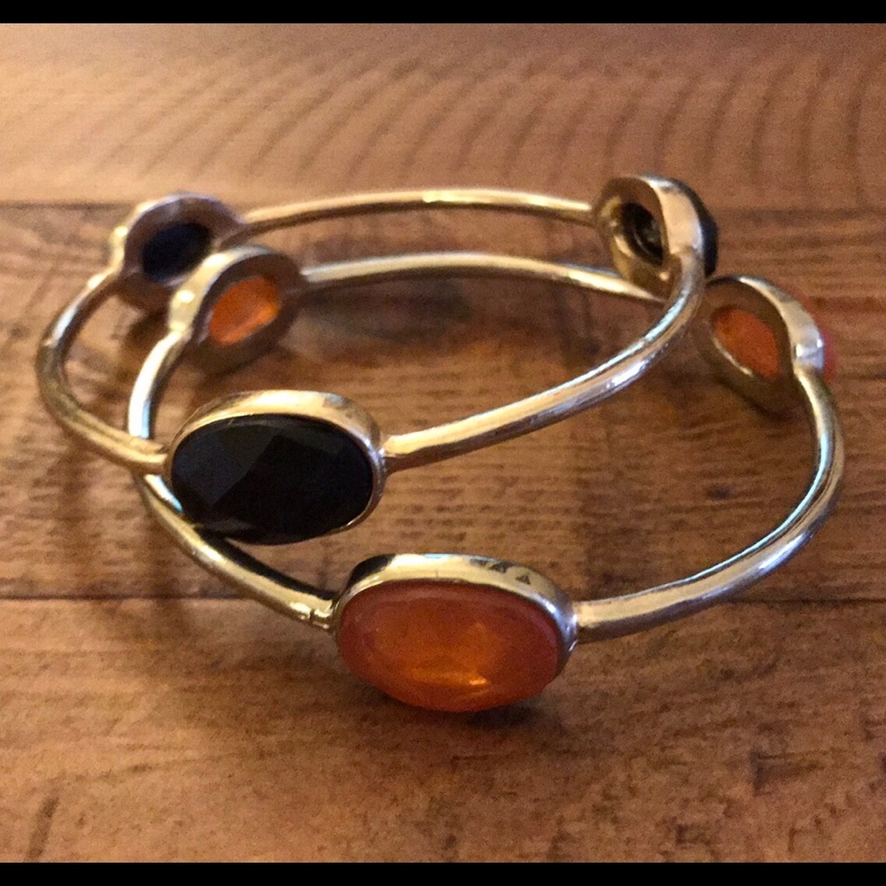 Two gold-colored, bejeweled bangles